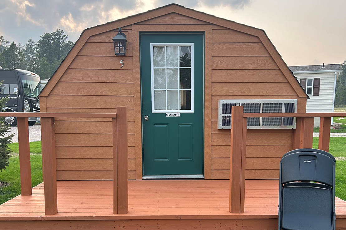 Camping cabin exterior at Custer Crossing Family Campground