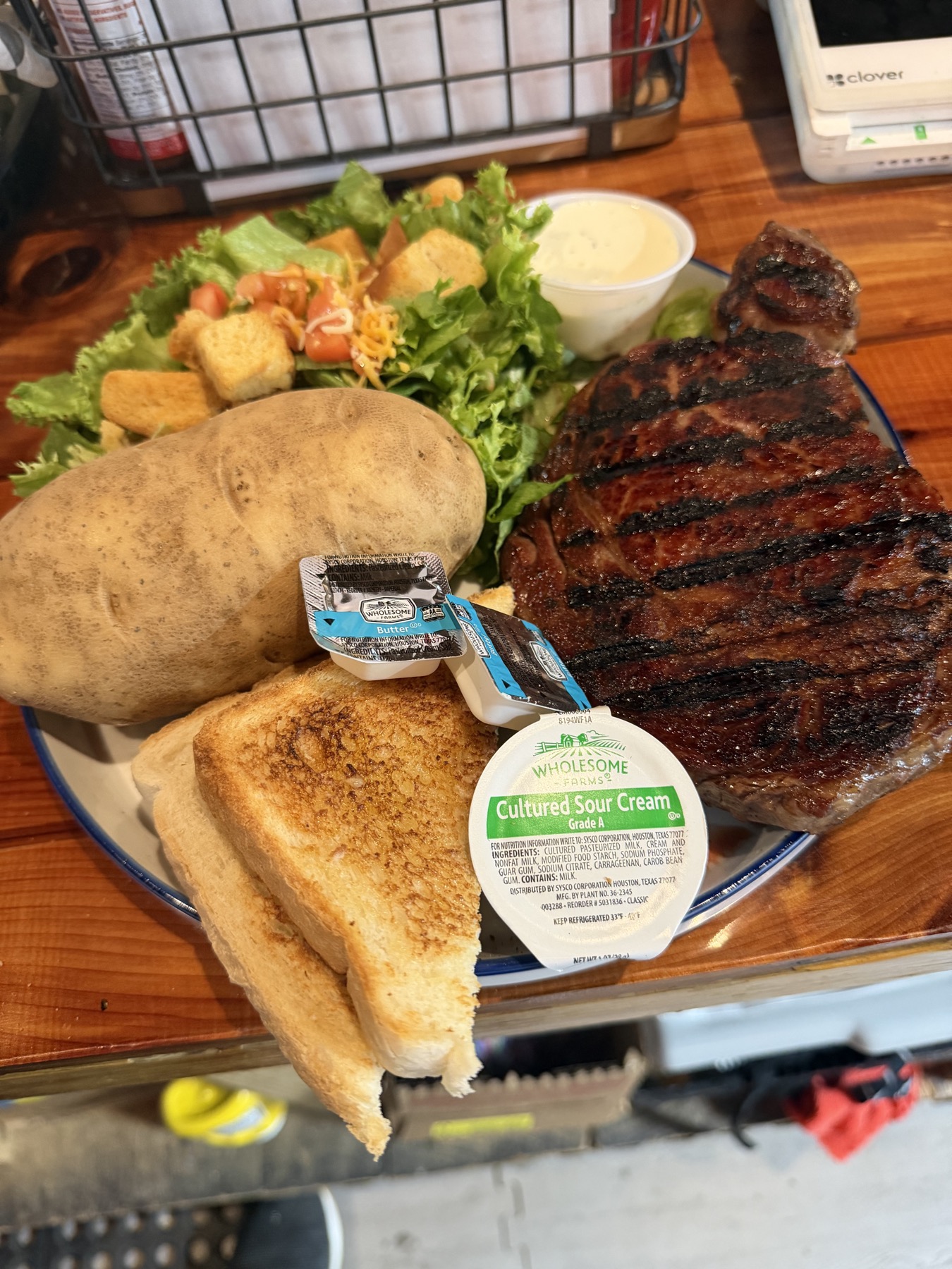 Steak dinner with baked potato, salad, and Texas toast at Custer's Last Meal