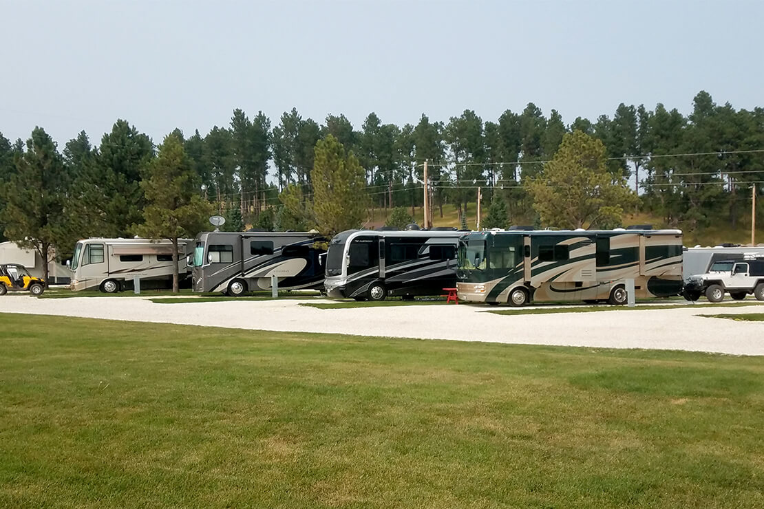 RV parked at a full-hookup campsite at Custer Crossing Family Campground